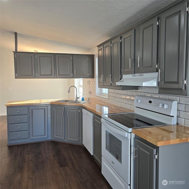 kitchen featuring lofted ceiling, sink, white appliances, butcher block countertops, and dark hardwood / wood-style flooring