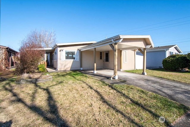 rear view of property featuring a carport and a lawn