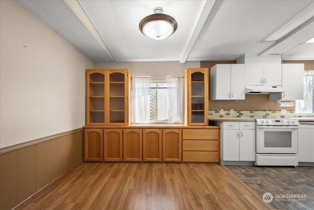 kitchen with white cabinets, light hardwood / wood-style flooring, and white range with electric stovetop