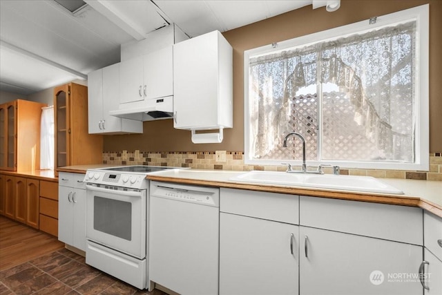 kitchen with sink, white appliances, a wealth of natural light, and white cabinets