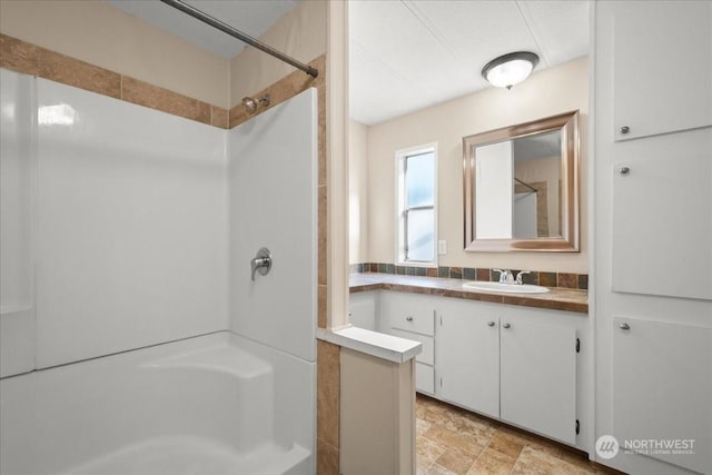 bathroom with vanity and walk in shower