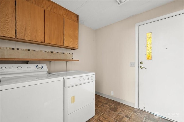 laundry area with cabinets and washer and clothes dryer