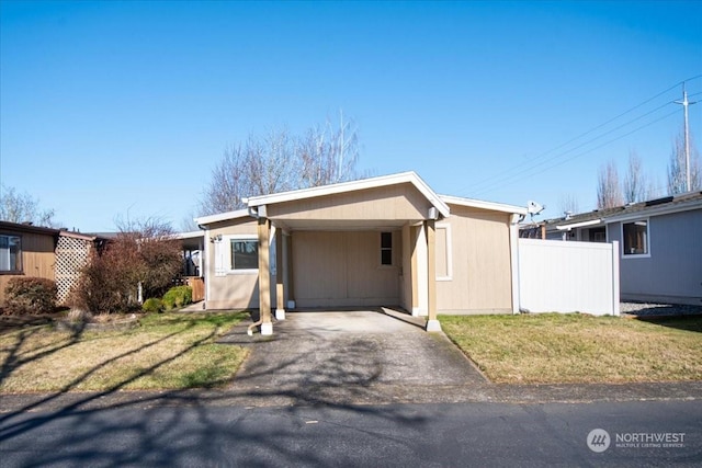 view of front of house with a carport and a front lawn