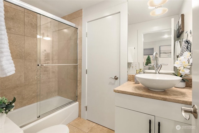 full bathroom with vanity, toilet, tile patterned flooring, and combined bath / shower with glass door