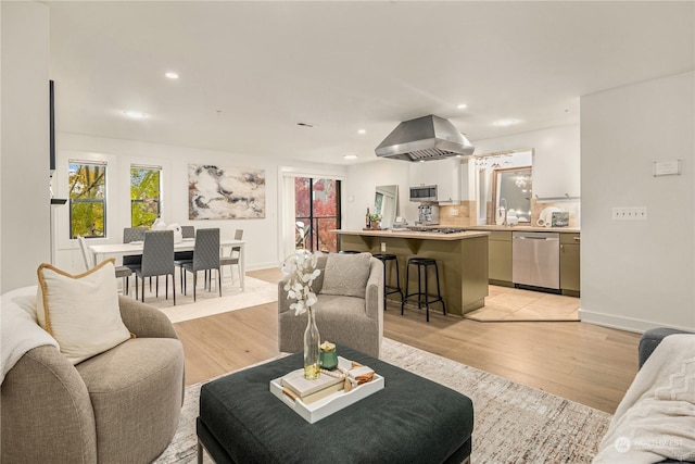 living room featuring sink and light hardwood / wood-style flooring