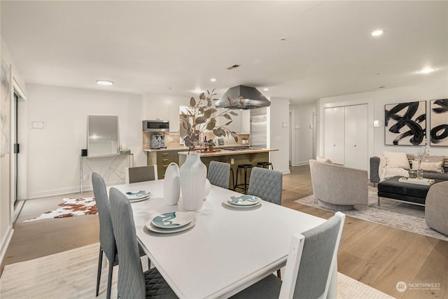 dining space featuring light wood-type flooring