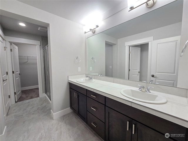 bathroom featuring vanity and a shower with shower door