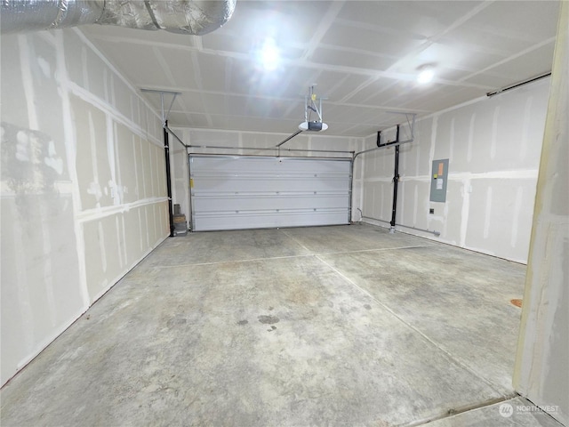 garage with a garage door opener and electric panel