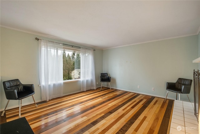 living room featuring ornamental molding and light hardwood / wood-style flooring