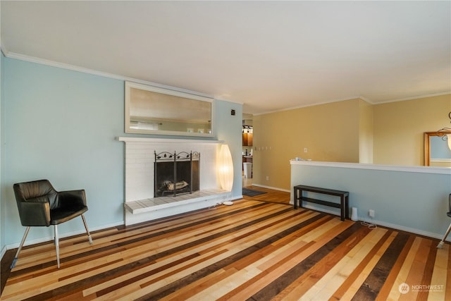 unfurnished living room with a brick fireplace, wood-type flooring, and ornamental molding