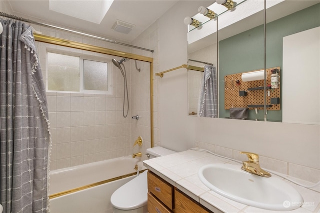 full bathroom featuring vanity, toilet, and shower / bath combo with shower curtain