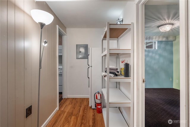 hall with electric panel and light wood-type flooring