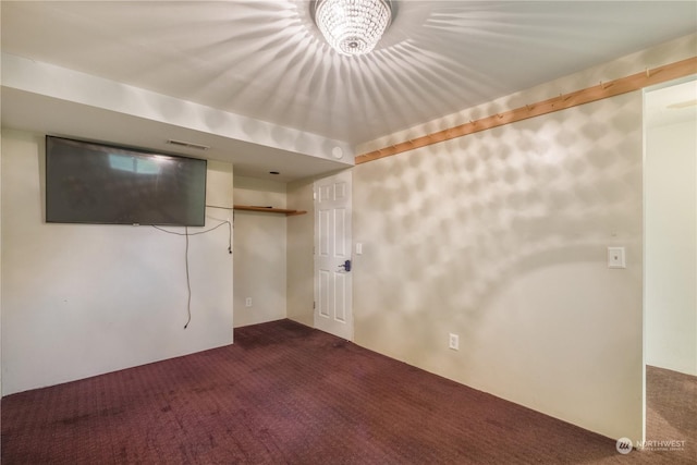 basement with dark colored carpet