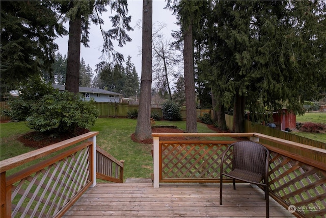 wooden terrace featuring a lawn