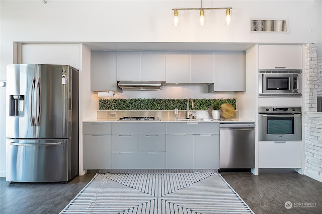 kitchen with sink, stainless steel appliances, and dark hardwood / wood-style floors