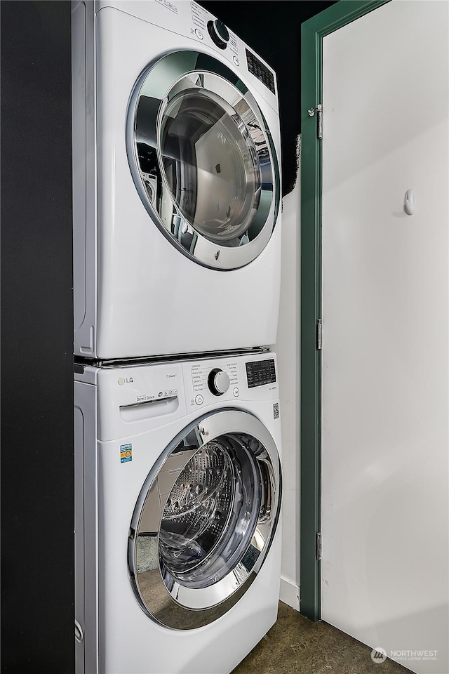 washroom featuring stacked washing maching and dryer