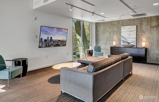 living room featuring floor to ceiling windows, carpet, and track lighting