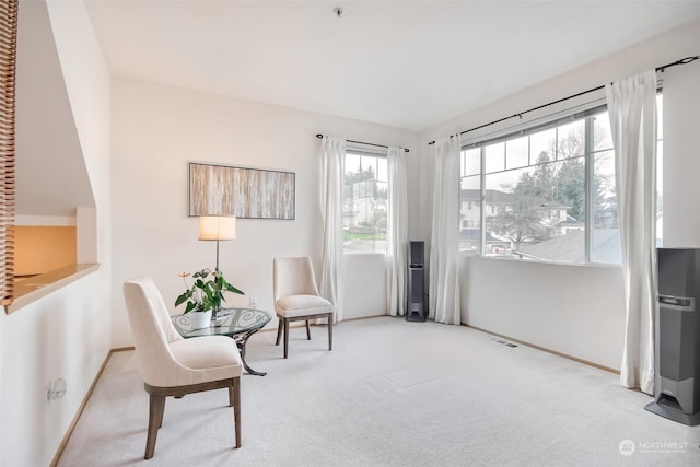 sitting room featuring visible vents, baseboards, and carpet