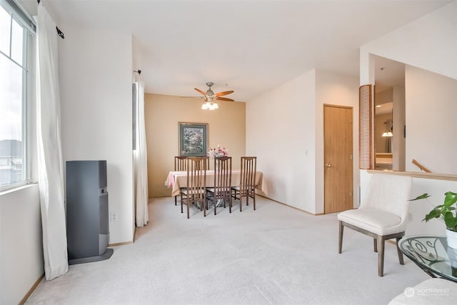 carpeted dining area featuring ceiling fan