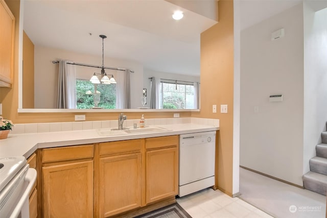 kitchen with pendant lighting, sink, stove, white dishwasher, and light brown cabinets