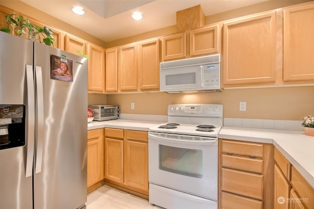 kitchen featuring white appliances, light brown cabinets, a toaster, recessed lighting, and light countertops