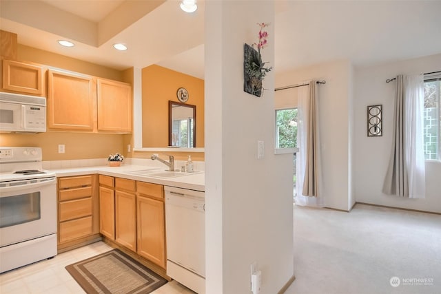 kitchen featuring white appliances, sink, and light brown cabinets