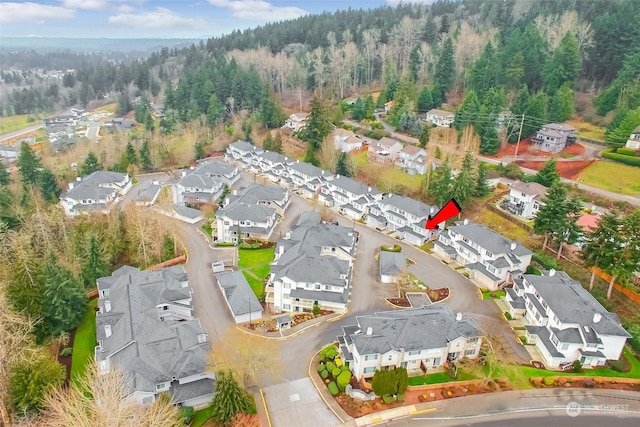 bird's eye view featuring a forest view and a residential view