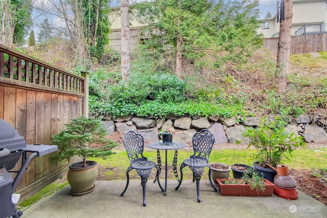 view of patio featuring fence