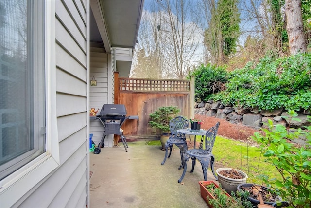 view of patio / terrace featuring a grill and fence