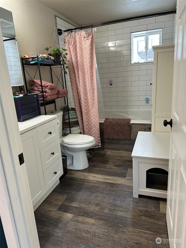 112 Haynes, Packwood, WA 98361 - full bathroom with a textured wall, tiled shower / bath, toilet, and wood finished floors