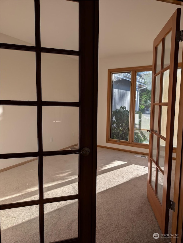 doorway to outside with carpet floors and french doors