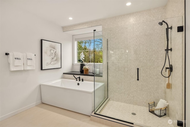 bathroom featuring separate shower and tub