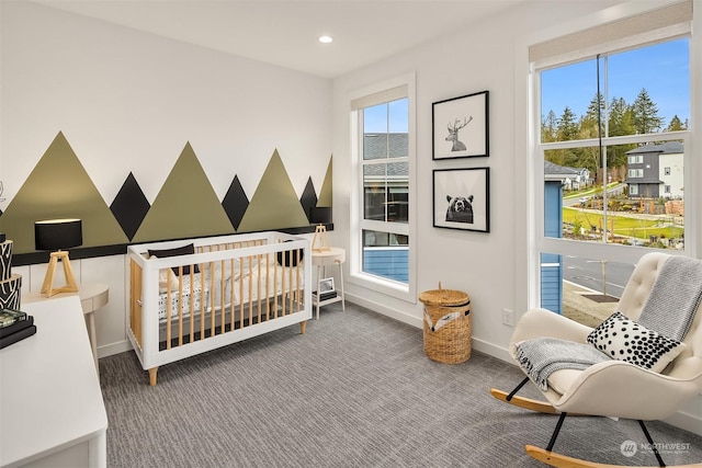 carpeted bedroom with a nursery area