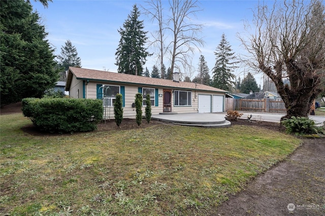 ranch-style house with a garage and a front lawn