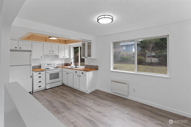 kitchen with butcher block counters, sink, white appliances, light hardwood / wood-style floors, and white cabinets