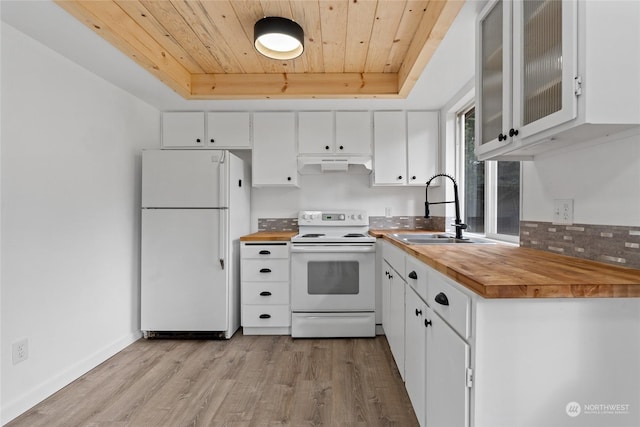 kitchen with white appliances, butcher block counters, a tray ceiling, white cabinets, and wooden ceiling