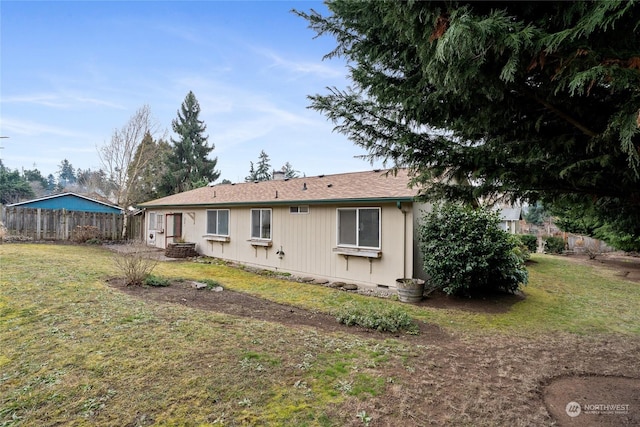 rear view of property featuring a yard