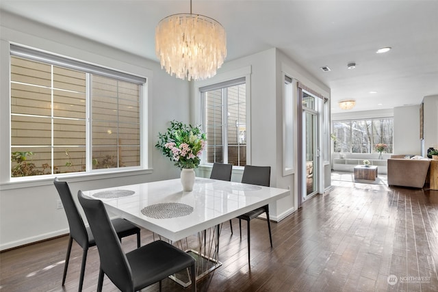 dining room featuring a chandelier and dark hardwood / wood-style flooring