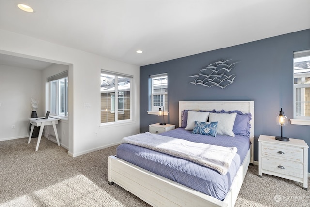 bedroom with multiple windows and carpet floors