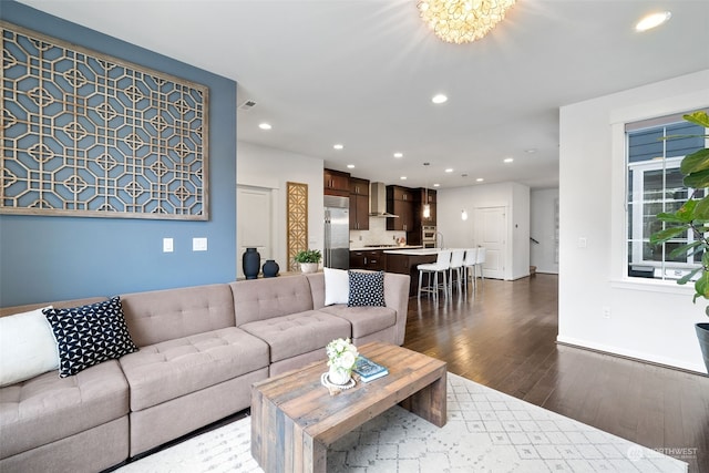 living room with dark hardwood / wood-style floors and a notable chandelier