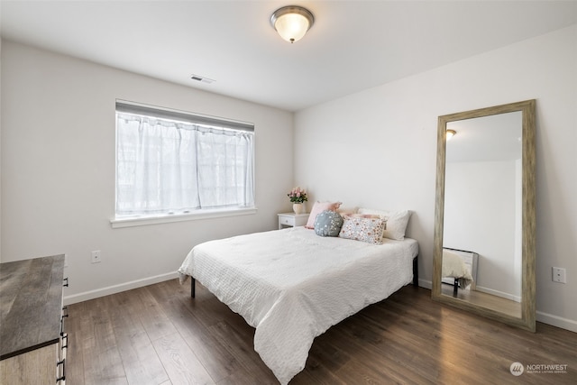 bedroom with dark hardwood / wood-style flooring