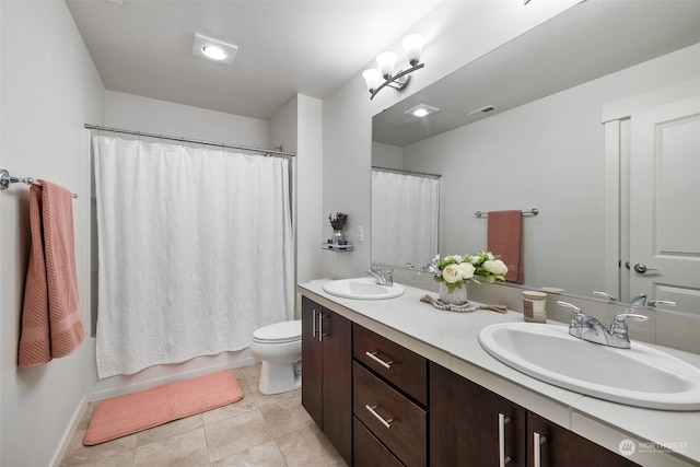 full bathroom featuring vanity, shower / bath combination with curtain, tile patterned floors, and toilet