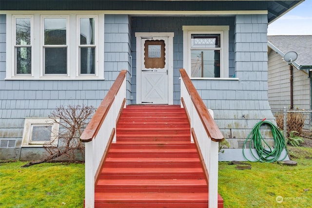 doorway to property featuring a yard