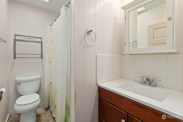 bathroom with tasteful backsplash, vanity, and toilet