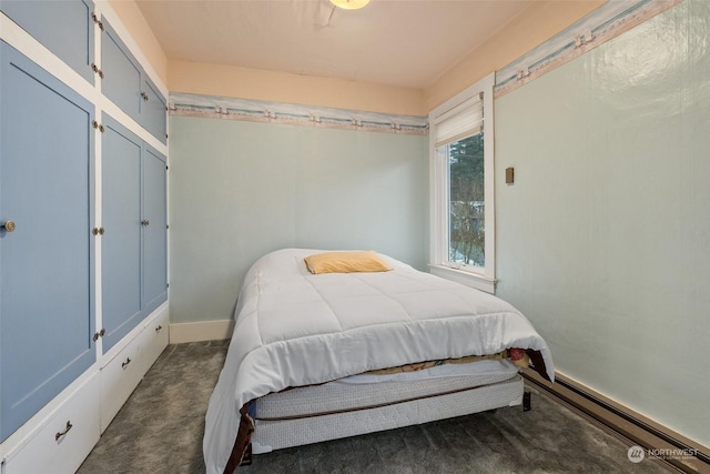 bedroom featuring dark carpet and baseboard heating