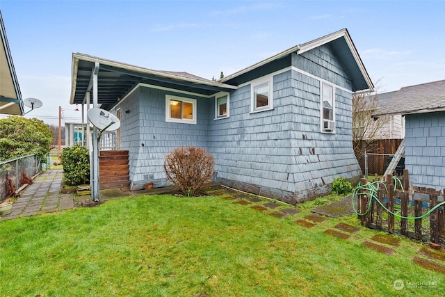 rear view of property featuring a yard