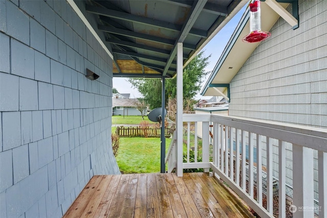 wooden deck featuring a lawn