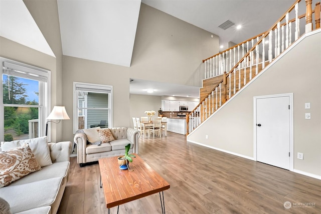 living room featuring hardwood / wood-style floors and a high ceiling