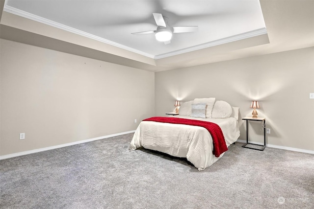 bedroom with crown molding, ceiling fan, carpet flooring, and a raised ceiling