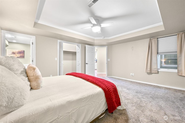 carpeted bedroom featuring crown molding, a raised ceiling, and ceiling fan